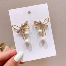 Load image into Gallery viewer, Cutout Bow Pearl Pendant Stud Earrings Bow Diamond Earrings Creative Simple Accessories Jewelry for Women